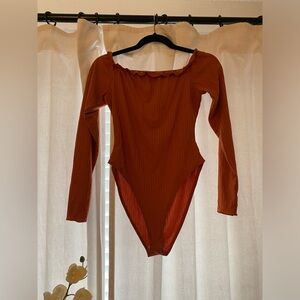 Orange off the should bodysuit